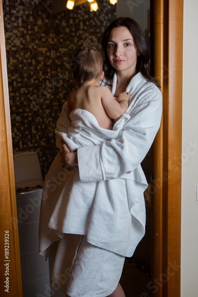 Fototapeta mother in a Bathrobe and with a child