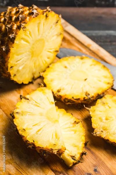 Fototapeta Fresh ripe pineapples on the rustic background. Selective focus.