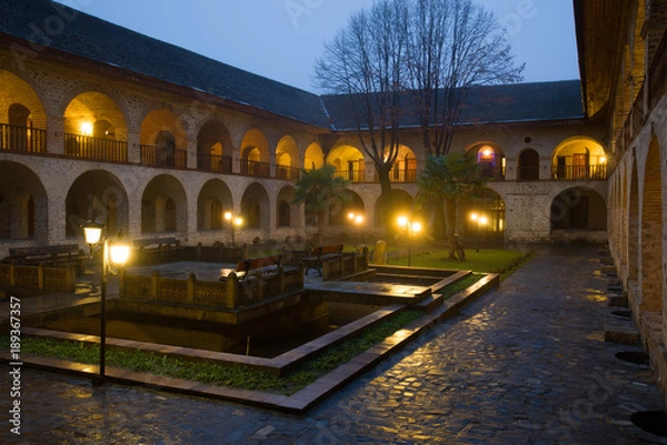 Fototapeta The courtyard of the ancient upper Caravanserai in the January twilight. Sheki, Azerbaijan