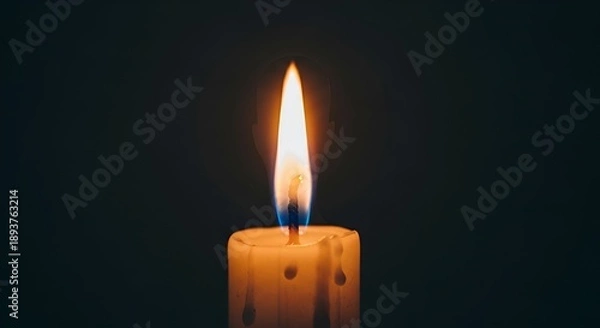 Obraz Single lit candle in darkness.