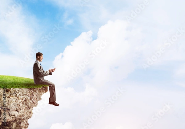 Fototapeta Businessman in suit with smartphone in hands send message