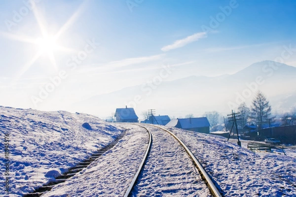 Fototapeta Railroad in snow covered mountains
