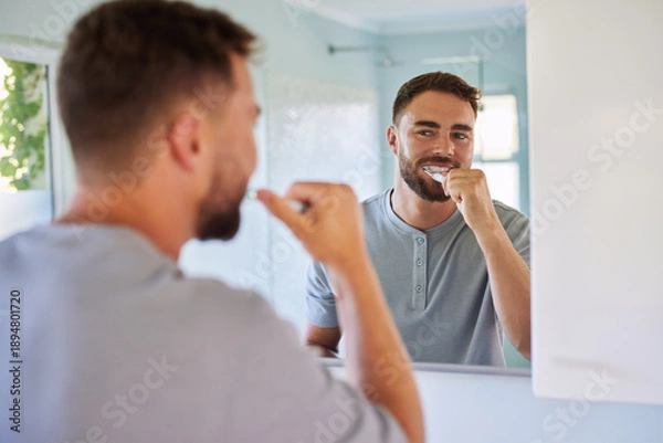 Obraz Man brushing teeth during morning routine