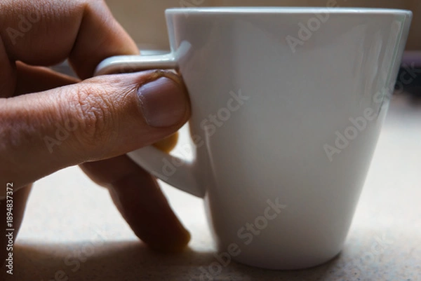 Fototapeta White coffee cup on table close up