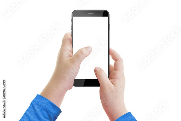 Obraz Little boy holding smartphone with empty screen in hands, isolated on white background