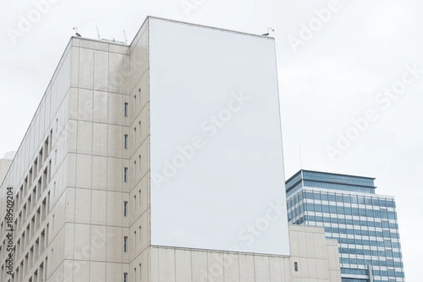 Fototapeta Large blank billboard on a street wall, banners with room to add your own text