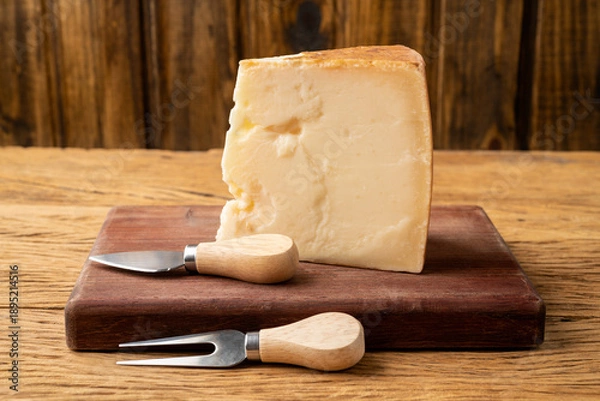 Obraz Parmesan cheese over wooden table