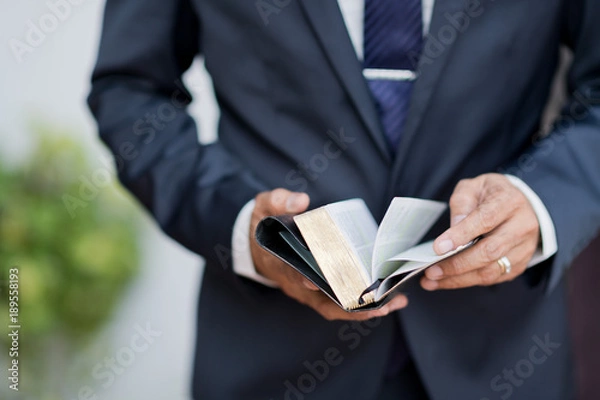Obraz Reading the book. Bible book. Open book in hands. holding a bible