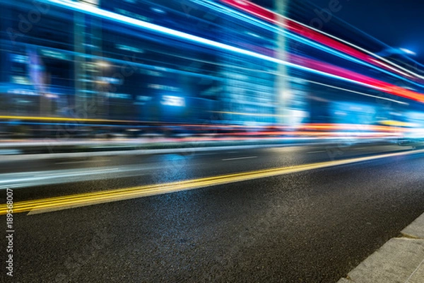 Fototapeta the light trails on the modern building background.