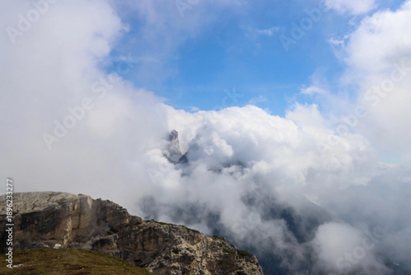 Obraz Dolomites spires covered by thick white clouds