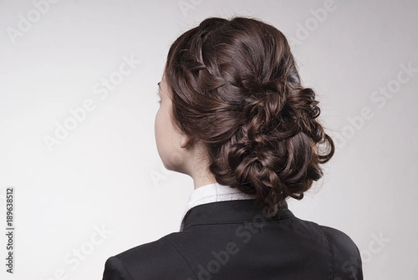 Obraz head of woman with brown hair in bun on gray isolated background rear view head turning to the left