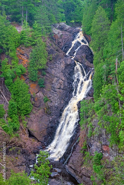 Obraz River Cascading Down Jagged Rocks in the Forest