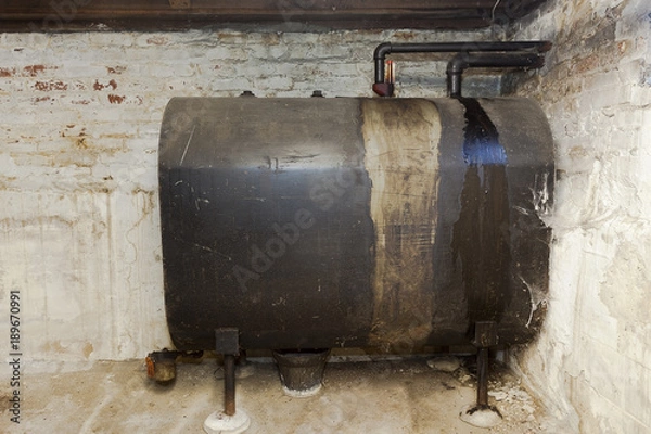 Obraz Old heating oil tank in dingy dank basement.