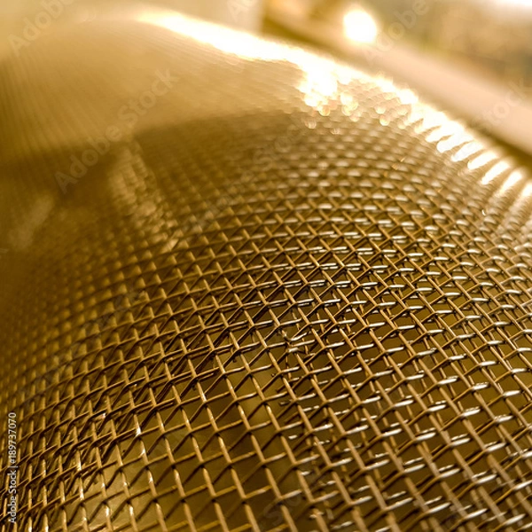 Fototapeta Gold mesh net with focus and shallow depto fo field, gold bokeh net pattern