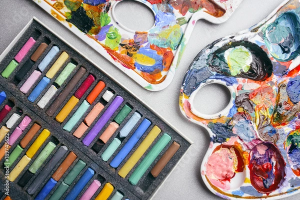 Obraz Multicolored crayons pastel and palette with paints. Creation.