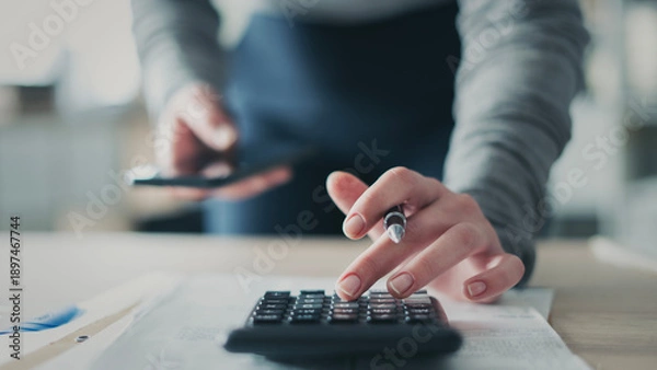 Obraz Close-up view woman's hand using a calculator