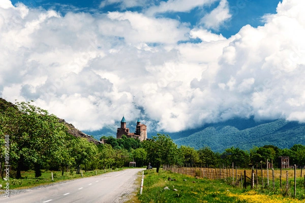 Fototapeta Gremi fortress - royal citadel and orthodox monastery and church complex in Kakheti, Georgia. Natural summer landscape of Kakheti region with mountains on the background.