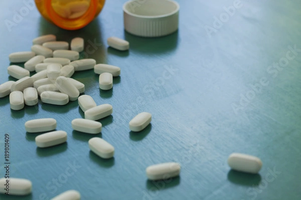 Obraz White Pills on a Teal Background