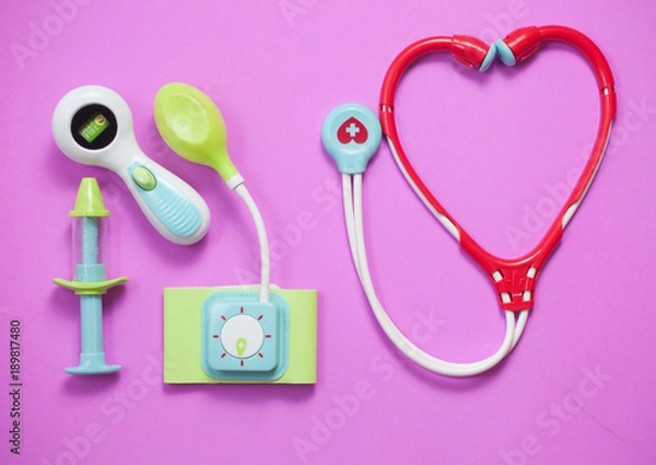 Fototapeta Top view of medical set toys on pink background
