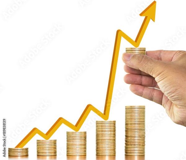 Fototapeta Stack of money coins arranged as graph with a man hand holding one coin and gold arrow up on money coin on white background, concept of money growth and saving money