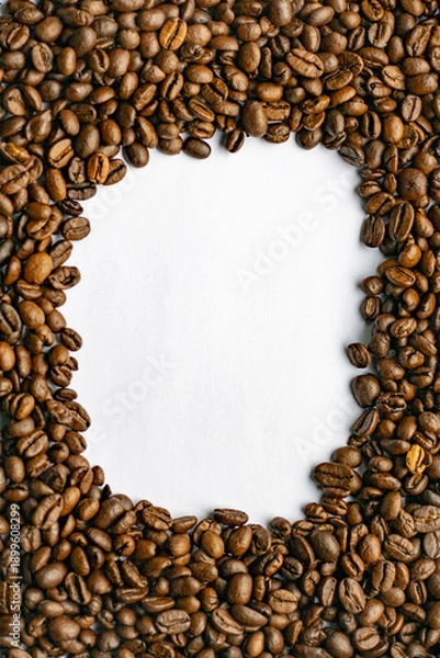 Obraz Coffee beans on a white background.