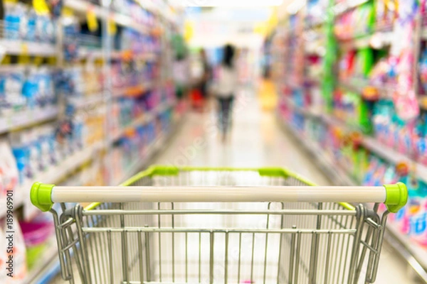 Obraz Supermarket store abstract blur background with shopping cart, Supermarket aisle with empty shopping cart