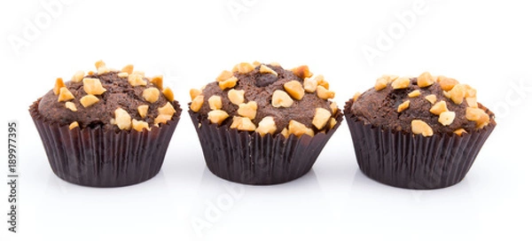 Fototapeta Group of chocolate muffins with nuts crumbs isolated on white background