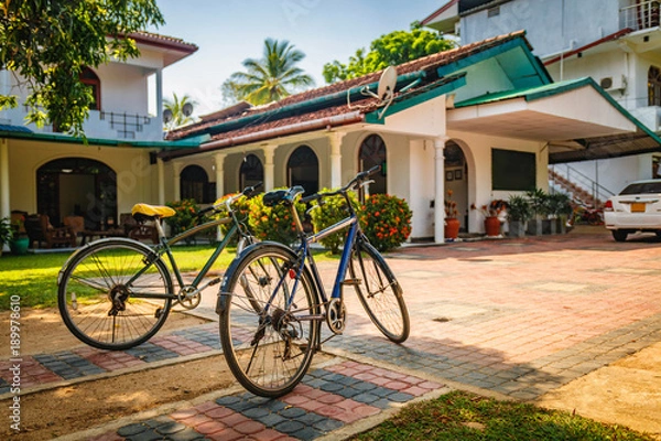 Fototapeta Two old bikes standing against the house in Polonnawuwa, Sri Lanka