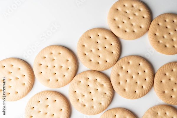 Obraz Round crackers arranged on white background