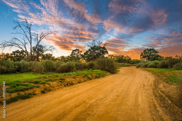 Obraz Rural Australian Landscape with colorful clouds ans dirty gravel road in Outback of Australia at sunrise/sunset
