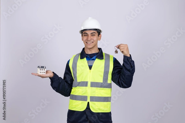 Obraz Professional engineer holding small device and pointing thumb
