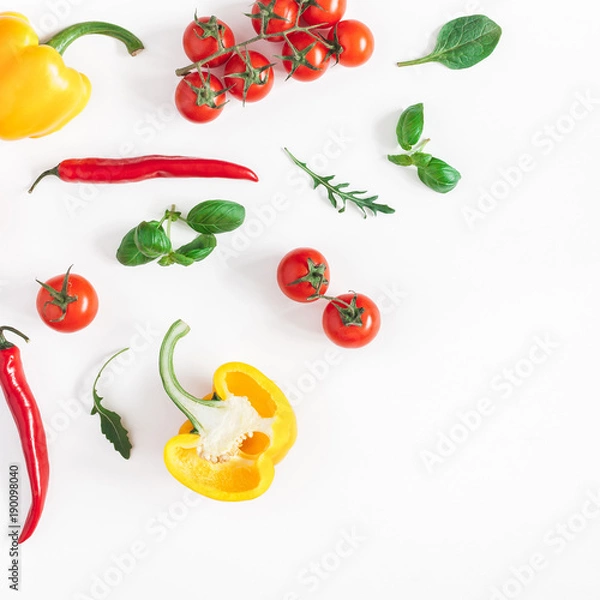 Fototapeta Vegetables on white background. Frame made of fresh vegetables. Tomatoes, peppers, green leaves. Flat lay, top view, copy space, square