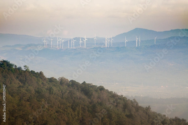 Fototapeta The windmill on the top of the mountain in Thailand with pink sky background.