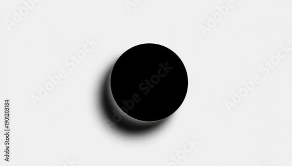 Obraz A stark black circle casts a shadow on a white background, highlighting its shape