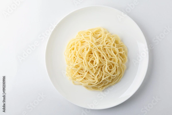 Obraz A plate of spaghetti pasta isolated on white background.