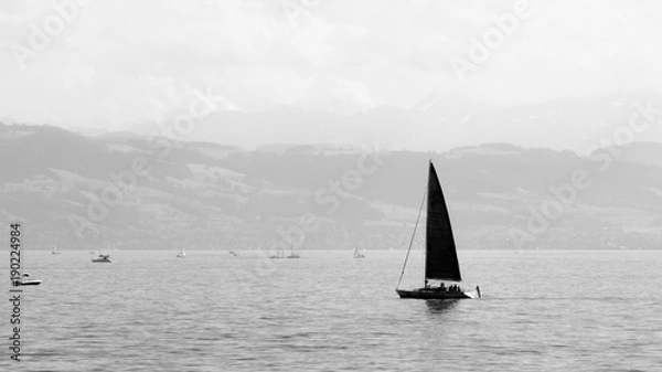Fototapeta Small Yacht sailing on the Bodensee, Germany in monochrome