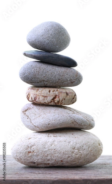 Fototapeta Balance Stones stacked placed on a wooden floor.