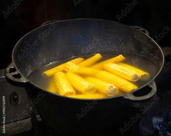 Obraz Yellow corn is cooked in a large cauldron