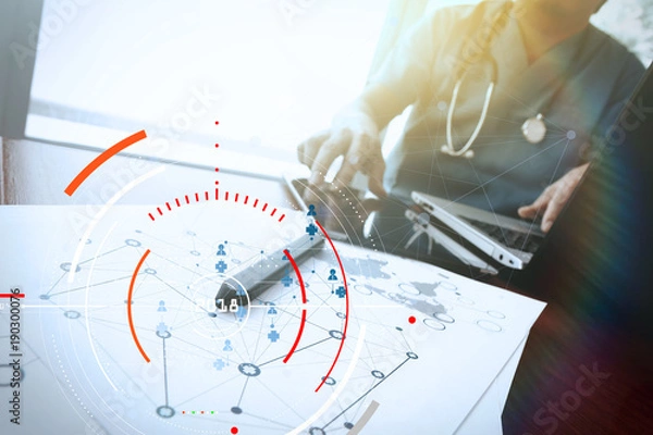 Fototapeta Doctor working with digital tablet and laptop computer in medical workspace office and medical network media diagram as concept