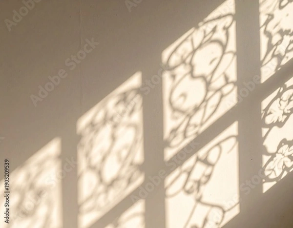 Obraz Warm sunlight casts decorative window shadows on a wall