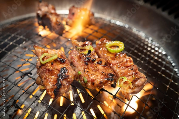 Obraz 網の上で炎を上げて焼けるジューシーな中落ちカルビ