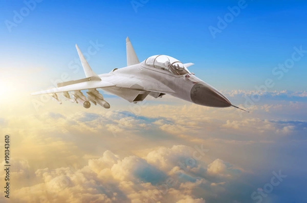 Fototapeta Military fighter aircraft at high speed, flying high in the sky sunset.