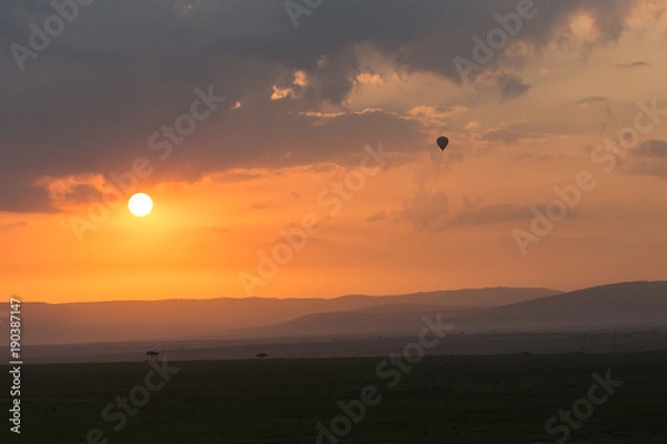 Fototapeta balloon against the clouds of a sunrise, Maasai Mara, Kenya