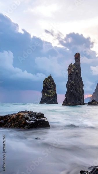 Obraz Dramatic sea stacks rise from the ocean under a cloudy sky