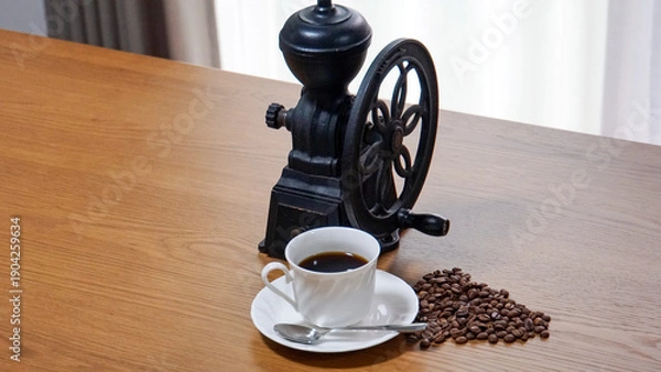 Obraz アンティークな雰囲気の黒いコーヒーミルといカップに注がれたブラックコーヒー