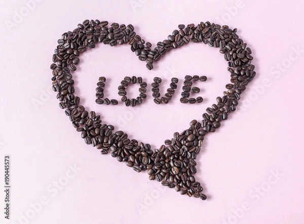 Fototapeta Decorative heart composed of coffee beans with 'LOVE' writing