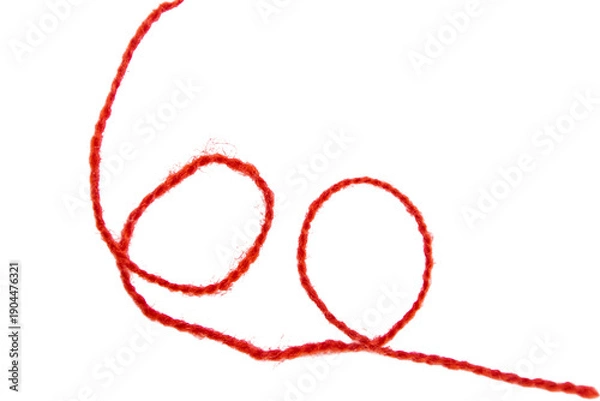 Fototapeta Red thread isolate on white background. Selective focus. Old.