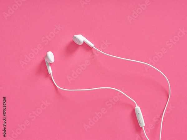Obraz White wired earbuds resting on pink background