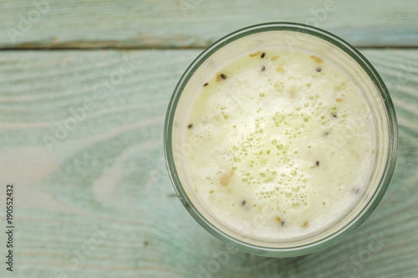 Fototapeta Glass with kiwi smoothies, top view