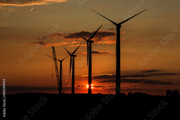 Obraz wind turbines at sunset with crane